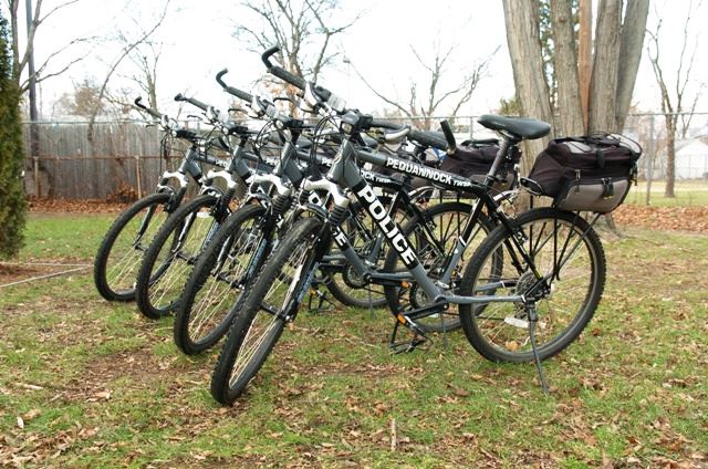 Four mountain bike in grass with Police logos